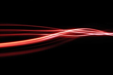 Dynamic red light trails on black background abstract motion