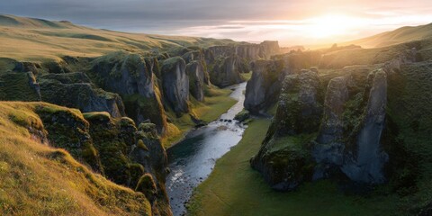 Sunrise over fjaðrárgljúfur canyon in iceland with lush greenery and river