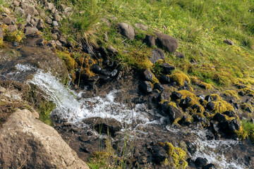 Mountain stream with rocks and moss in Iceland. Toned.