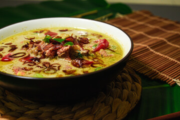Soto Betawi, Creamy beef or offal soup made with coconut milk, spices, tomato, onion, shallot, an Indonesian specialty.