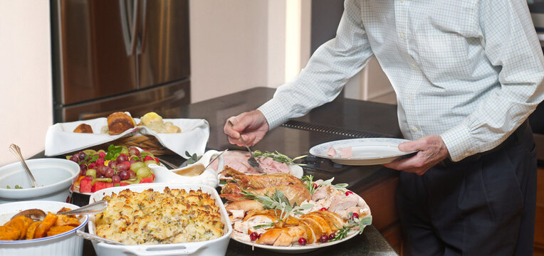 Men making a plate for Thanksgiving dinner