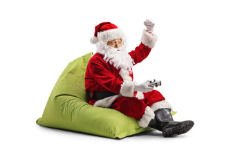 Happy Santa claus holding a joystick and cheering with hand