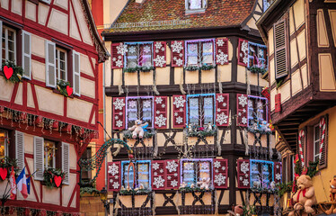Fototapeta premium Festive decorations on half timbered houses, Colmar Christmas Market in France