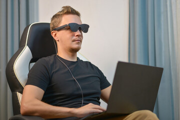 Man Using Wearable AR XR Smart Glasses While Using Laptop