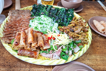 Abundant Vietnamese Family Style Meal Platter Featuring Fresh Spring Rolls Grilled Meats And Leafy Greens