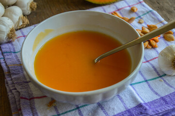 Homemade pumpkin soup in a bowl with a spoon. Autumn food.