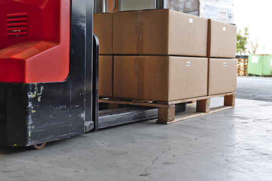 Low angle view of electric pallet stacker loading pallet