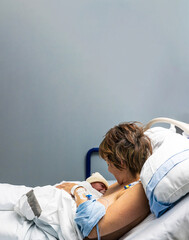 Mother holding newborn baby skin to skin after birth