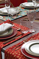 Close-up of sophisticated table settings with plates, cutlery, bowls, and glasses for beautiful events and dinners.