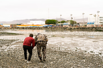 Men birdwatching and exploring wetland environment
