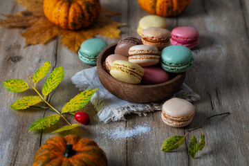 Macarons of different colors and flavors in a wooden bowl