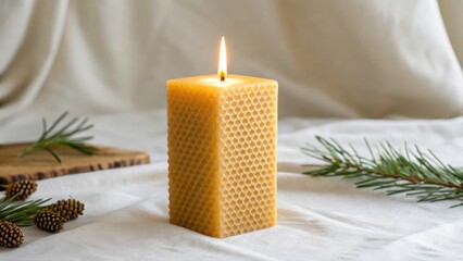 A beeswax candle burning with a bright yellow flame