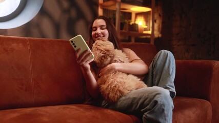 relaxed evening with pet, gentle evening leisure with furry companion, serene night scene featuring woman and her loyal dog, woman unwinding comfortably on sofa alongside her faithful canine friend