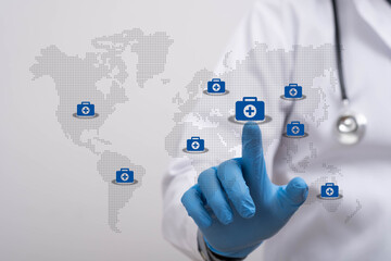 Doctor wearing medical gloves touching a digital healthcare icon on a world map, representing global medical services, telemedicine technology, online diagnosis, and international health connectivity.