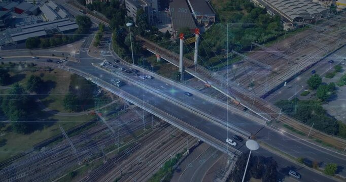 Drone camera starting oblique sweep, diagonal overpass carrying cars crossing tracks for monitoring