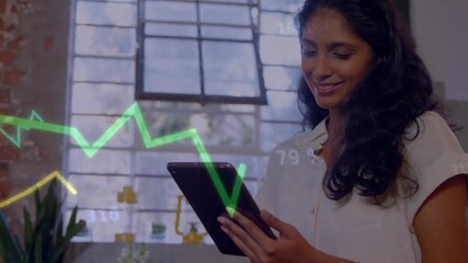 Businesswoman tapping tablet, causing finance graphs sweeping across window while analyzing data - Powered by Adobe