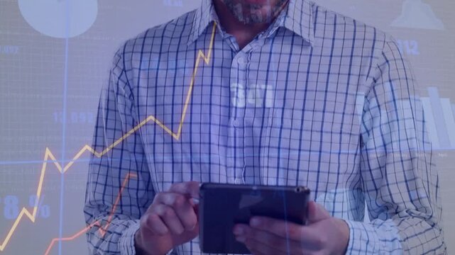 Male analyst holding tablet, tapping swiping, viewing financial chart overlays while camera rising