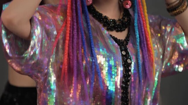 A vivid spectrum of colors radiates from a person's dazzling iridescent sequin attire and strikingly multi-toned hair, embodying vibrant self-expression