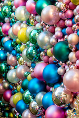 A Background Texture of colorful Christmas Bauble Decorations on the wall.