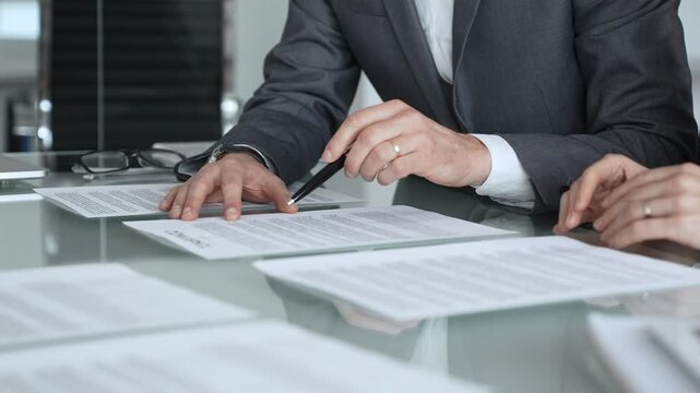 Business professionals discussing contract terms, lawyer explaining clauses, clients making agreements during a corporate meeting. Business people concept