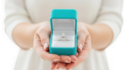 Womans hands holding an open teal engagement ring box with a sparkling diamond ring inside, symbolizing love and commitment, isolated on transparent background