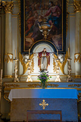 Statue of the Sacred Heart of Jesus prominently displayed on the altar of the Christian church of S&atilde;o Sebasti&atilde;o da Pedreira in Lisbon.