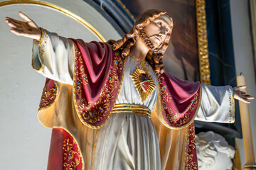 Statue of the Sacred Heart of Jesus prominently displayed on the altar of the Christian church of S&atilde;o Sebasti&atilde;o da Pedreira in Lisbon.