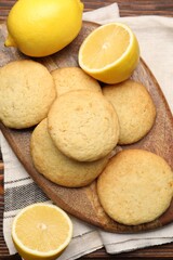 Tasty lemon cookies and fruits on wooden table, flat lay