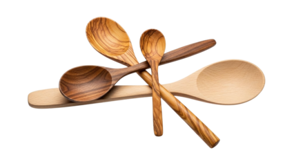 A collection of various wooden spoons, including olive wood and light wood, stacked and intertwined, isolated on transparent background