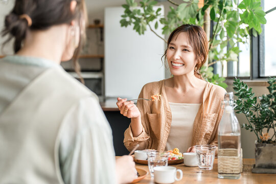 A woman eating a delicious lunch with her female friends and mom friends (girls' get-together)
