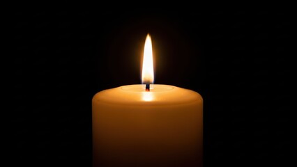 Closeup of a single lit white candle burning brightly with a warm flame against a solid black background, symbolizing remembrance, hope, or mourning
