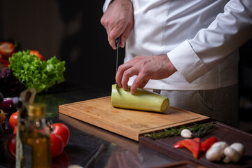 Chef Slicing Zucchini in Kitchen