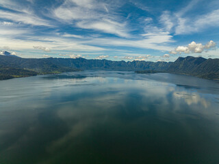 Lake Maninjau with reflected sky and clouds. Sumatra, Indonesia.