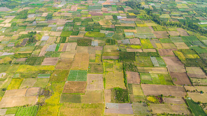 Aerial view of farmland in the countryside. Agricultural landscape in Sumatra. Berastagi, Indonesia.