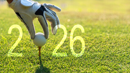 Close up hand Golfer woman putting golf ball for Happy New Year 2026 on the green golf for new healthy.  copy space. Healthy and Holiday Concept