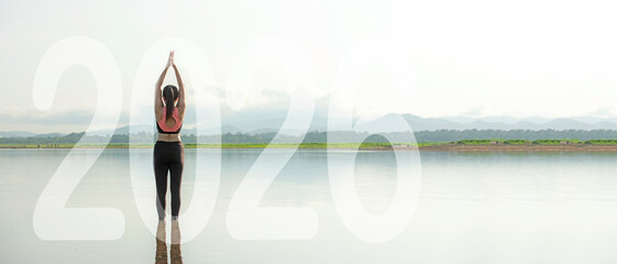 Obraz premium Happy new year start up 2026. Yoga women lifestyle exercise and pose for healthy life. people balance body vital zen and meditation for workout sunrise morning nature background for success 2026