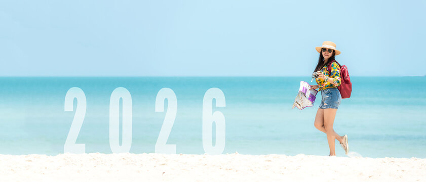 Asian young woman happy  jumping congratulation and celebrate in Happy New year 2026 for change new life future concept. Freedom lifestyle jump as part of Number 2026 success on the sand beach outdoor