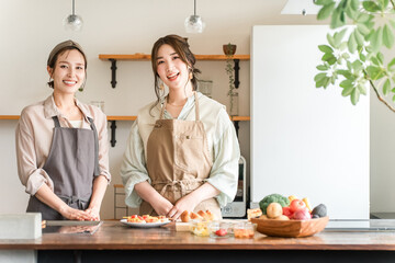 A female instructor and a female student teaching cooking at a cooking class/cooking school
