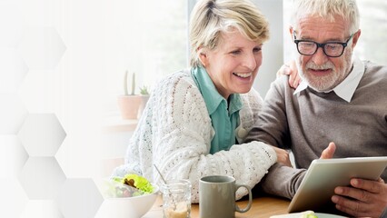 Senior couple using a tablet remix