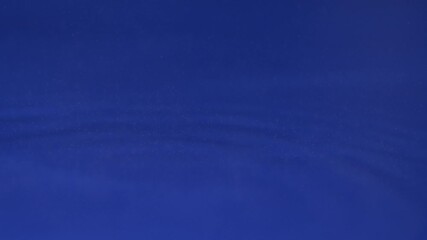 Calm water ripples create soothing visuals on a deep blue background for relaxation and focus