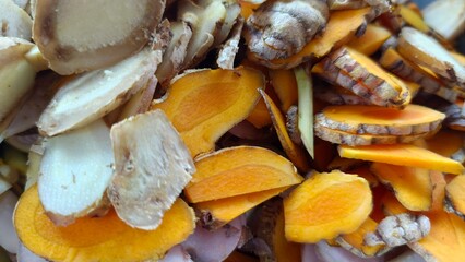Close-up slices of turmeric, ginger, and herbal roots. Perfect for health content, organic product...