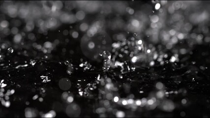 Rainwater splashes creating ripples in a dark puddle during a rainy afternoon - Powered by Adobe