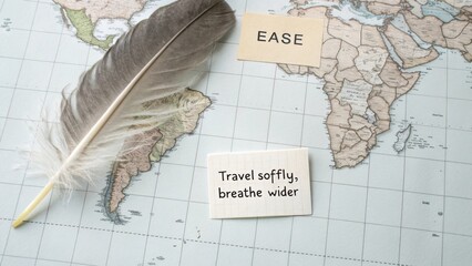 Explore global journeys with ease, inspiring travel quotes on vintage map background featuring soft feather and motivational text
