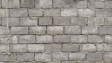 Fototapeta premium Gray brick wall texture perfect for backgrounds, architecture design, industrial themes, and creative visual projects.