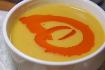 Delicious bowl of creamy soup with colorful swirl topping