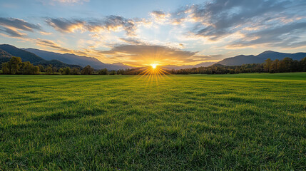 Fototapeta premium Sunrise field mountain sky grass meadow sunbeam calm horizon