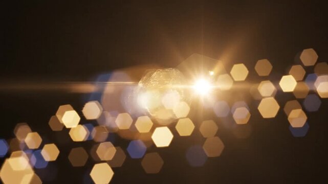 Hexagonal shapes bokeh in a lens flare overlay against black background hexagon