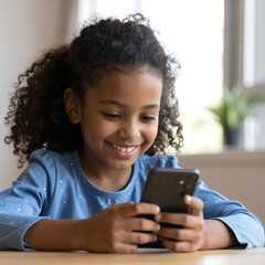 Smiling young girl intently uses a smartphone, looking at the screen