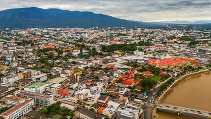 Fototapeta premium drone aerial of Chiang Mai Thailand cityscape old town temples mountains and ping river