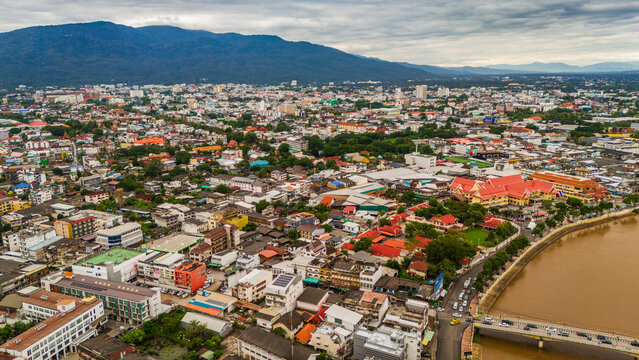 drone aerial of Chiang Mai Thailand cityscape old town temples mountains and ping river - Powered by Adobe
